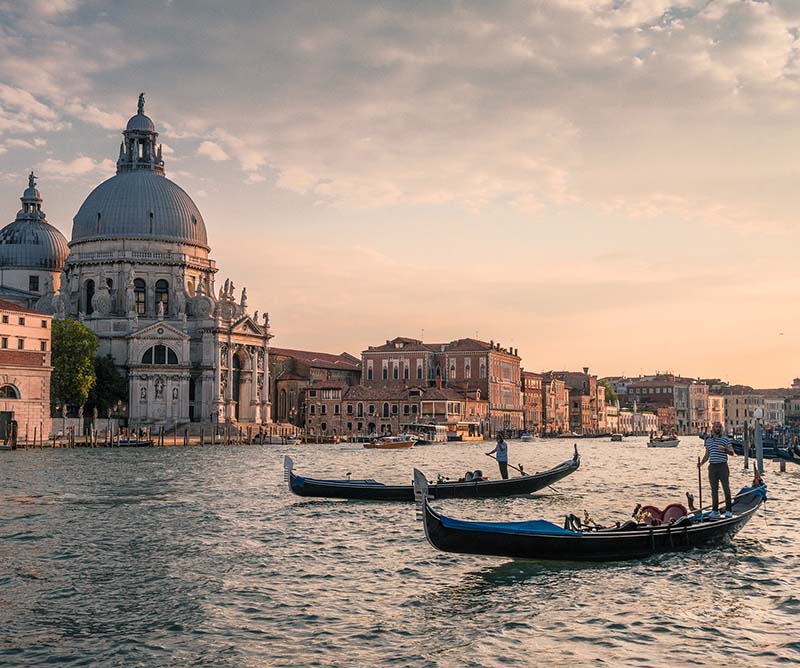 Venice at golden hour, with gondolas on the Grand Canal
