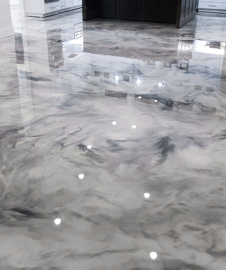 Glossy silver metallic epoxy floor reflecting recessed lights