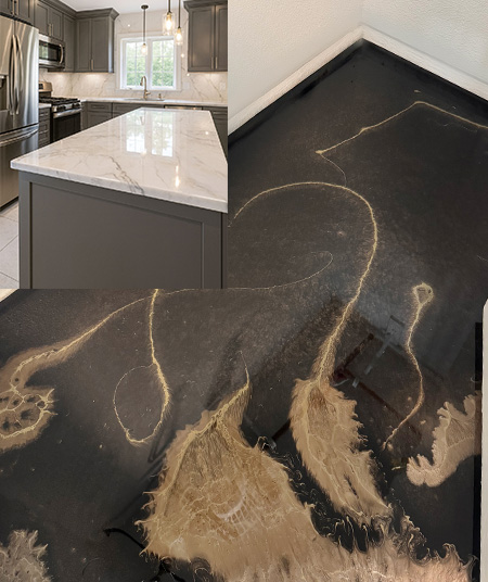 White marble-look epoxy island over a black-and-gold epoxy floor
