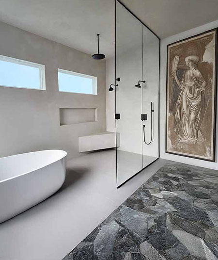 Tadelakt plaster bathroom with a freestanding tub and stone floor